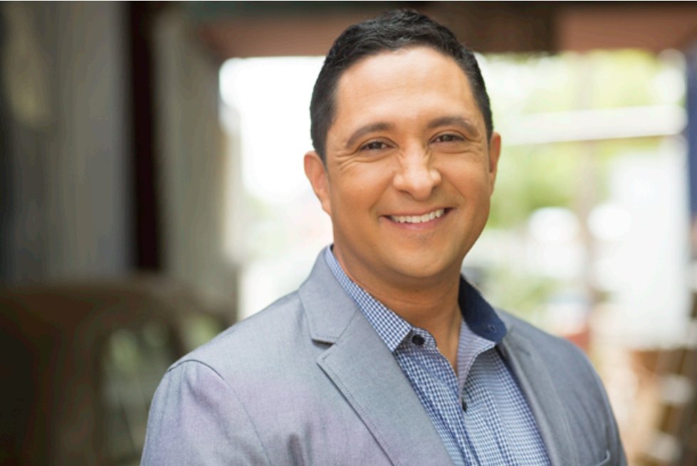 Juan Bedia on a client call as an Austin real estate agent